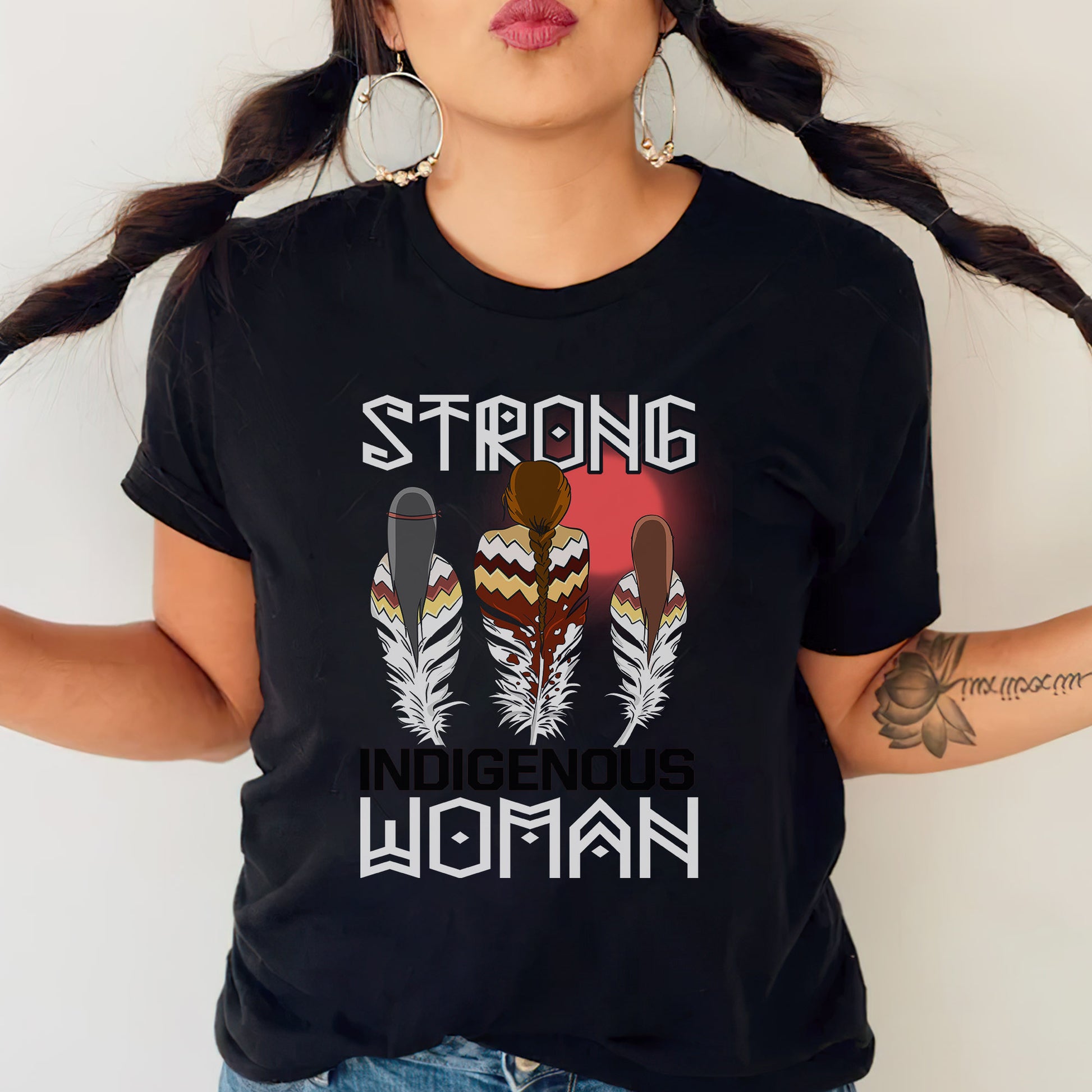 a woman wearing a black t - shirt that says strong is the woman