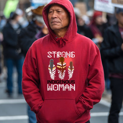 a man in a red hoodie stands in the street