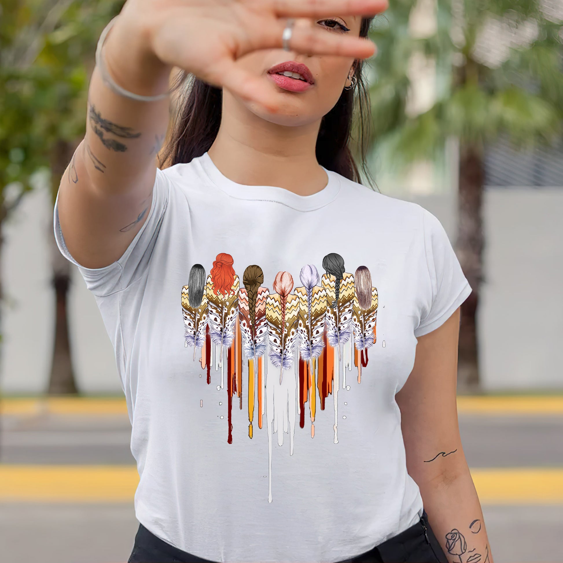 a woman wearing a white t - shirt with a picture of birds on it