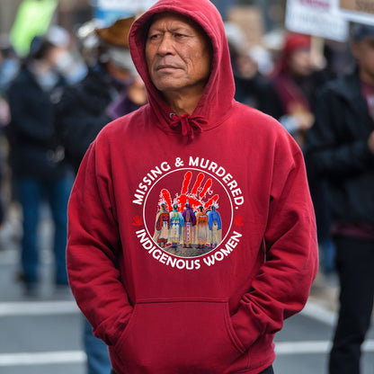 a man in a red hoodie stands in front of a crowd