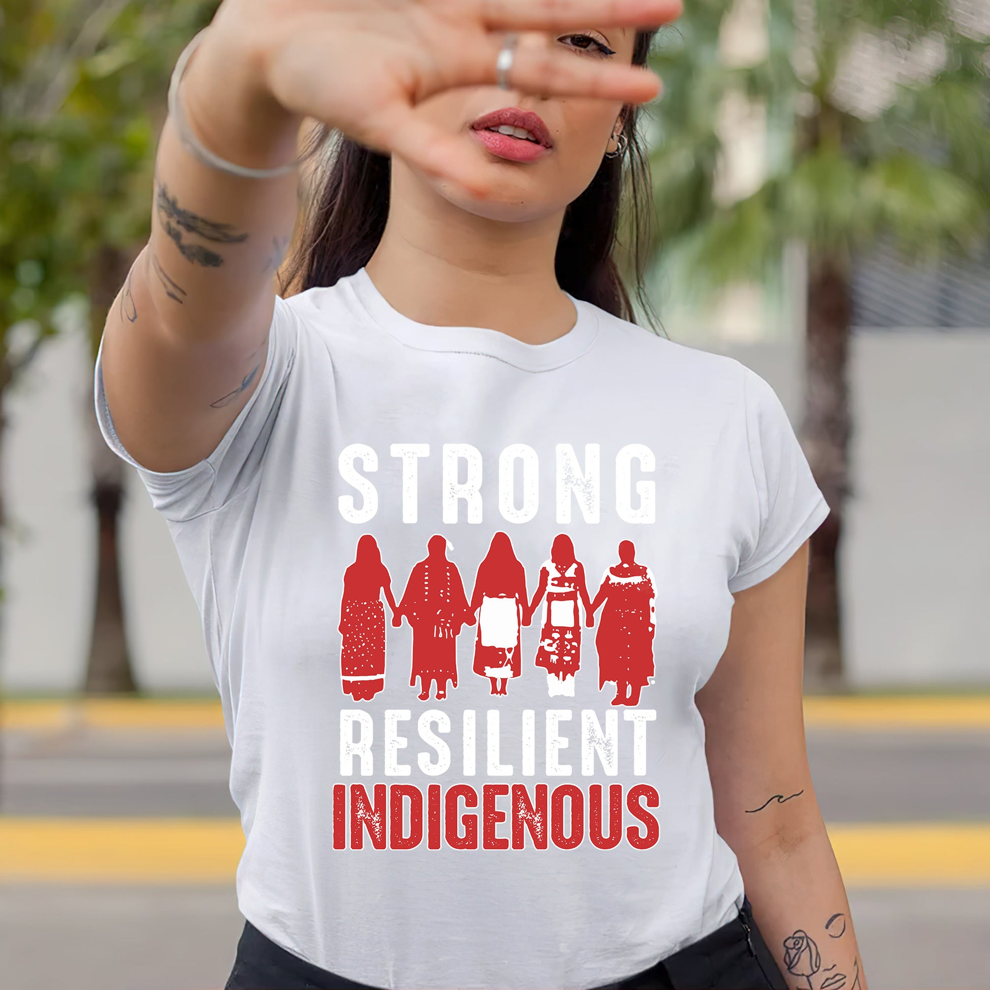 a woman wearing a t - shirt that says strong resilint indigenousness