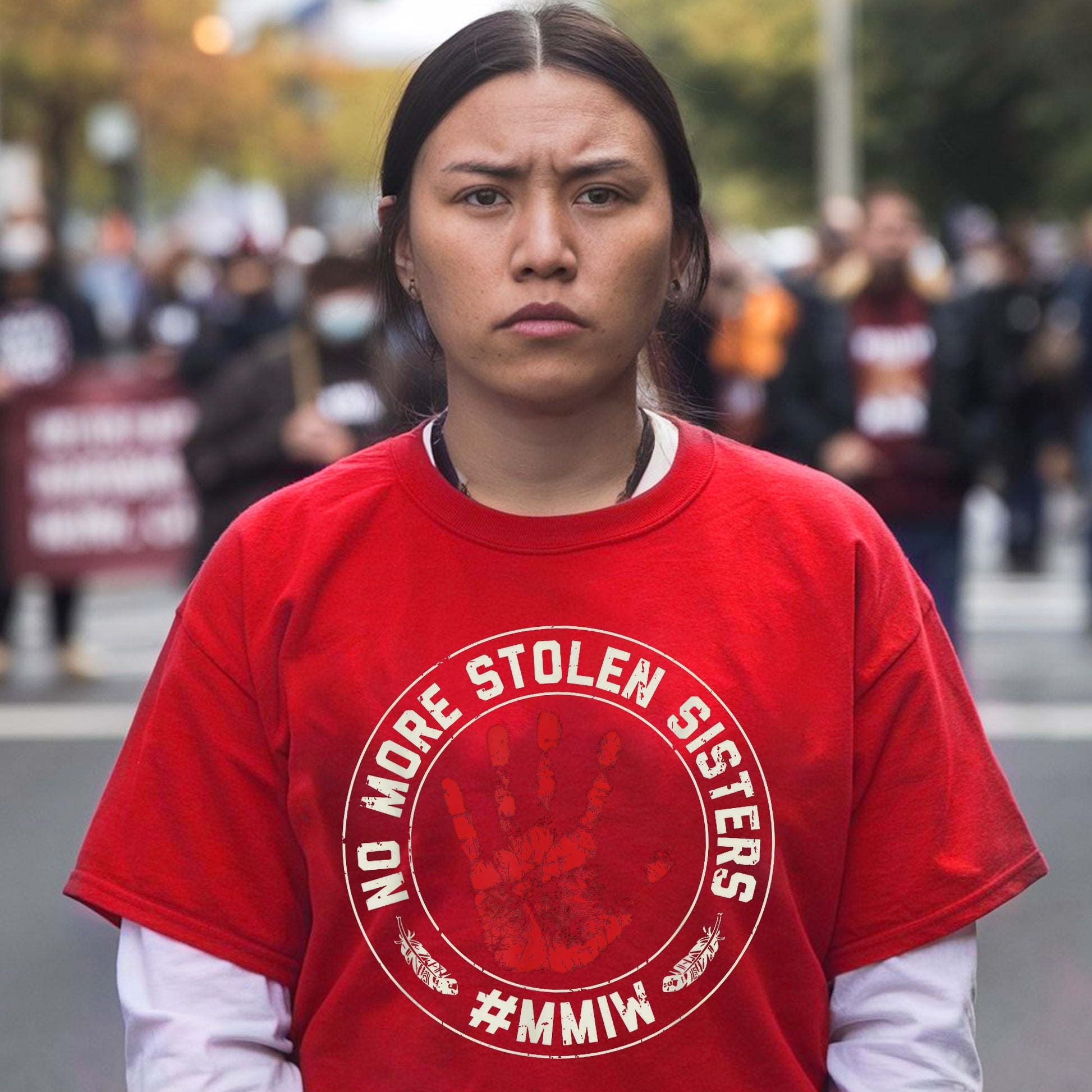 a woman in a red shirt is standing on the street