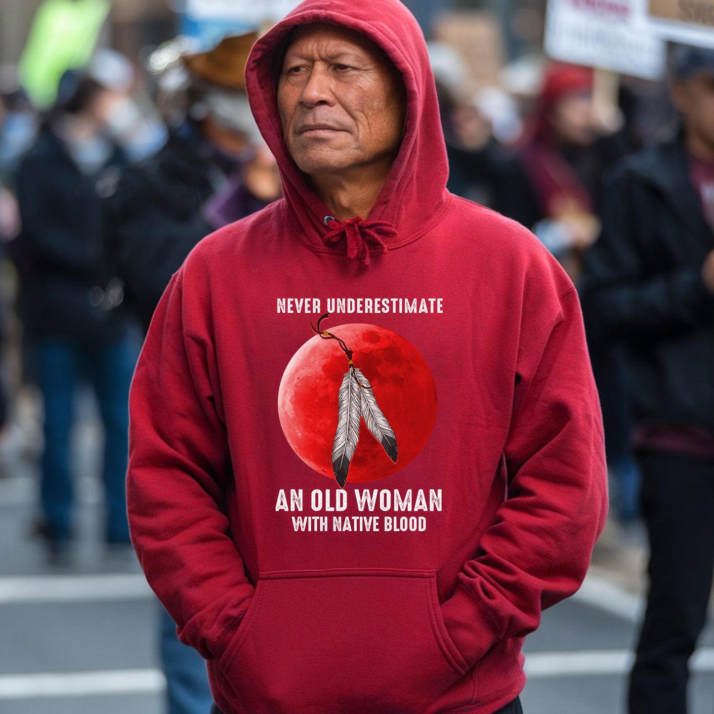 a man wearing a red hoodie with a picture of an old woman on it