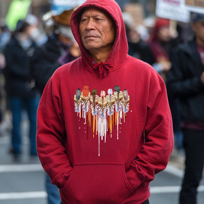 a man wearing a red hoodie with a group of people on it