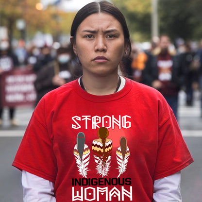 a woman wearing a red shirt that says strong indigenous woman