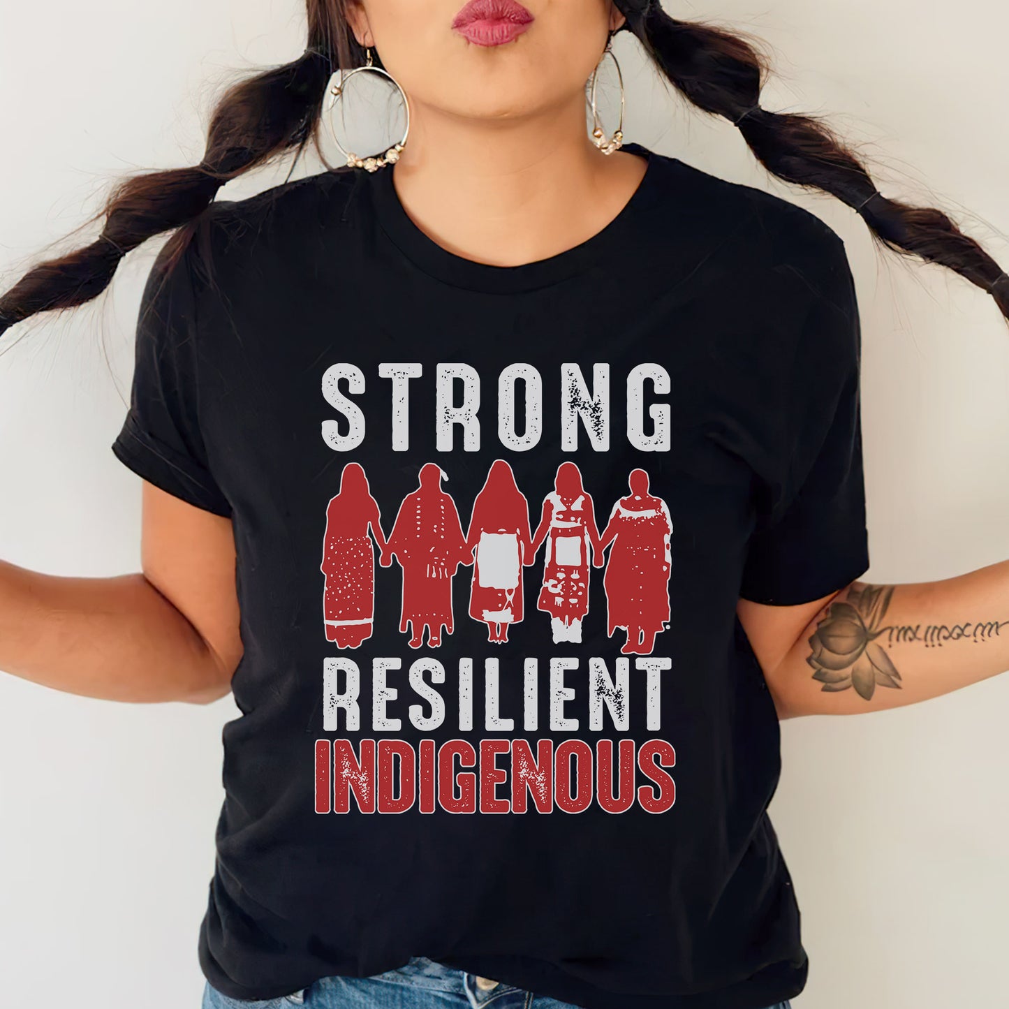 a woman wearing a t - shirt that says strong, resilint, indigenous