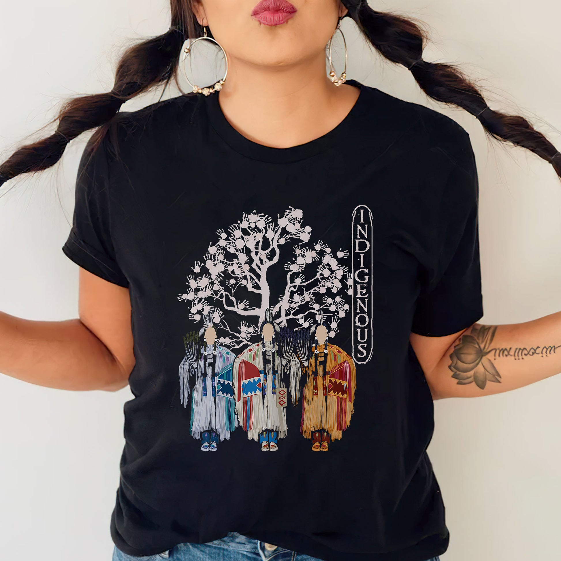 a woman wearing a black shirt with a tree on it