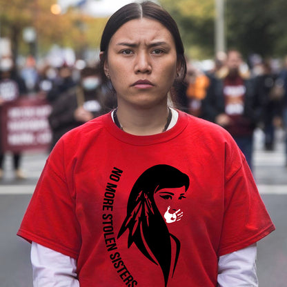 a woman in a red shirt is standing on the street