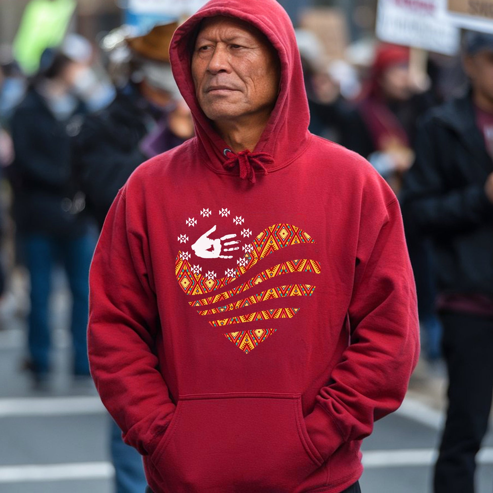 a man wearing a red hoodie with a heart on it