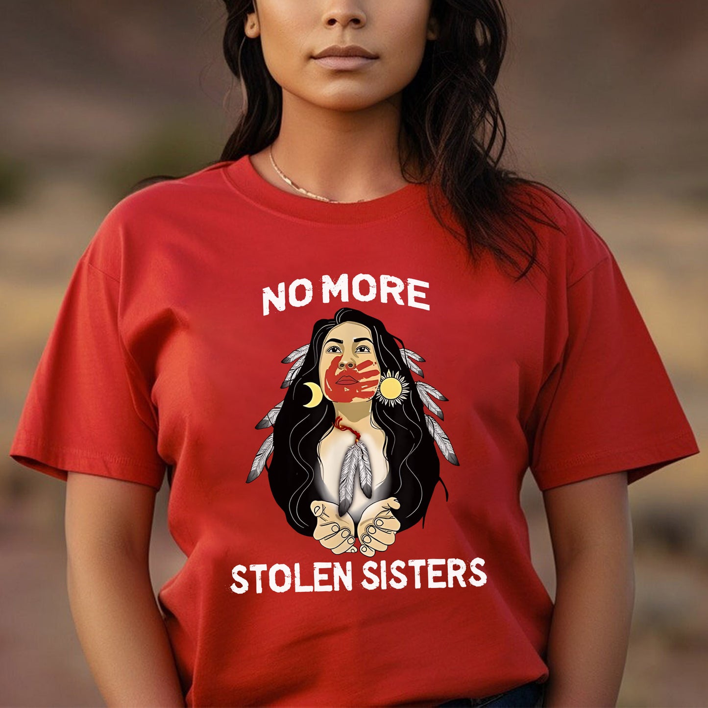 a woman wearing a red shirt that says no more stolen sisters