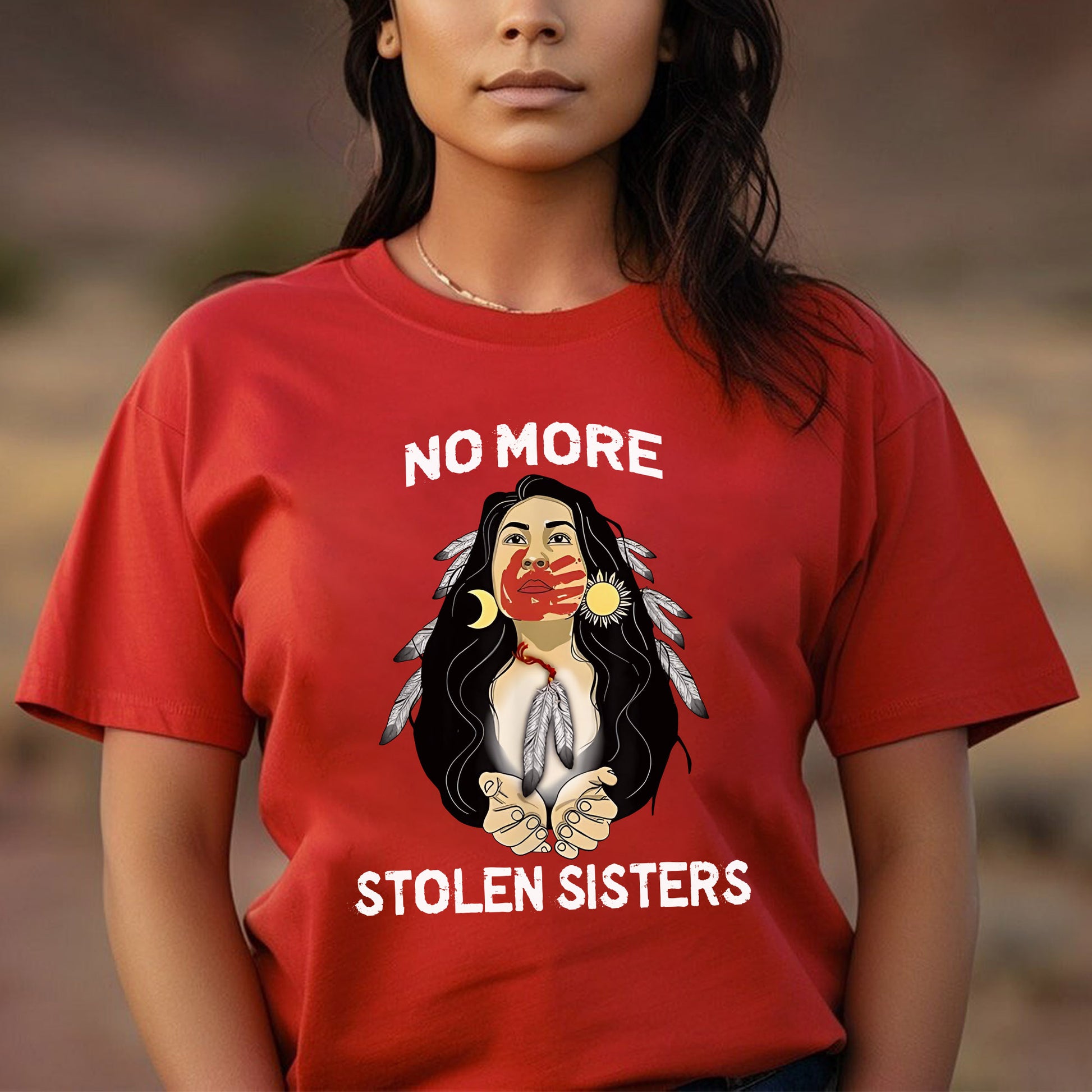 a woman wearing a red shirt that says no more stolen sisters