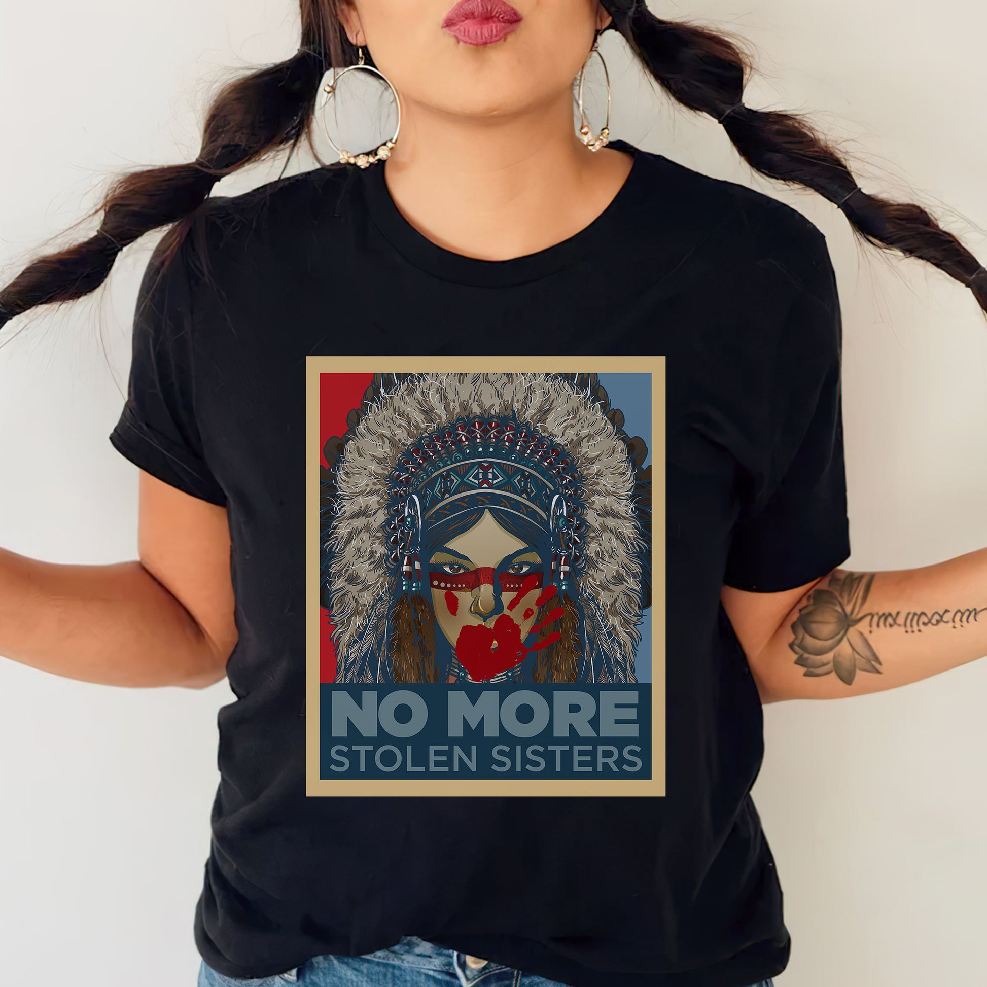 a woman wearing a black t - shirt with a picture of a native american woman