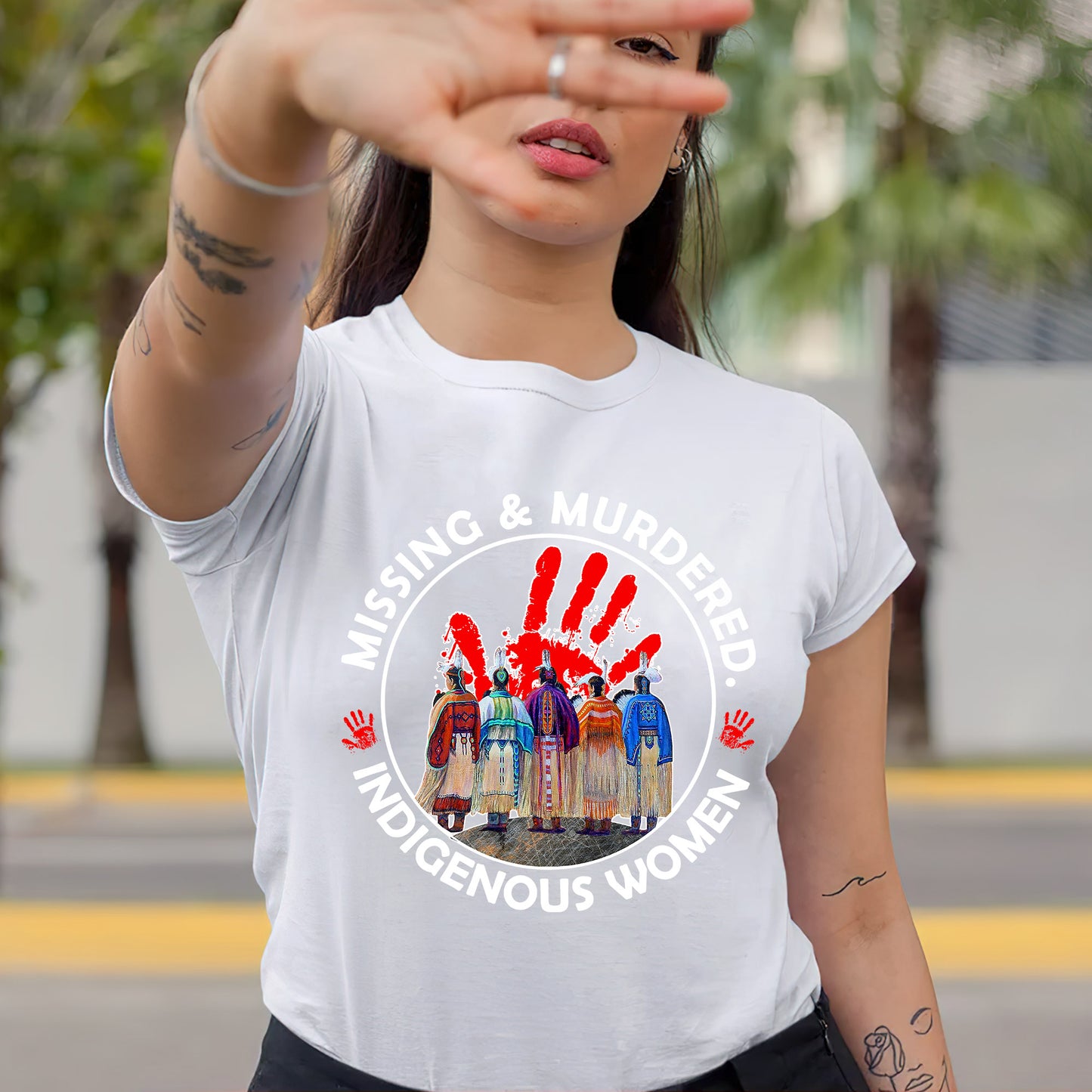 a woman wearing a white t - shirt with the words missing and murdered indigenous women