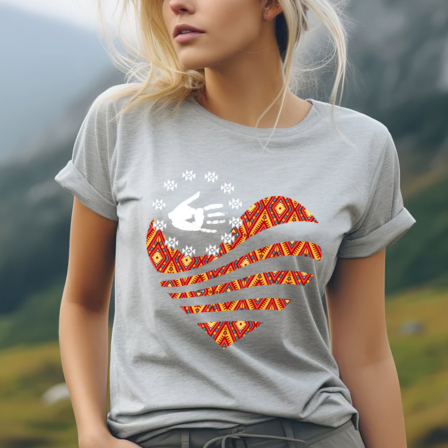 a blonde woman wearing a gray shirt with an american flag on it