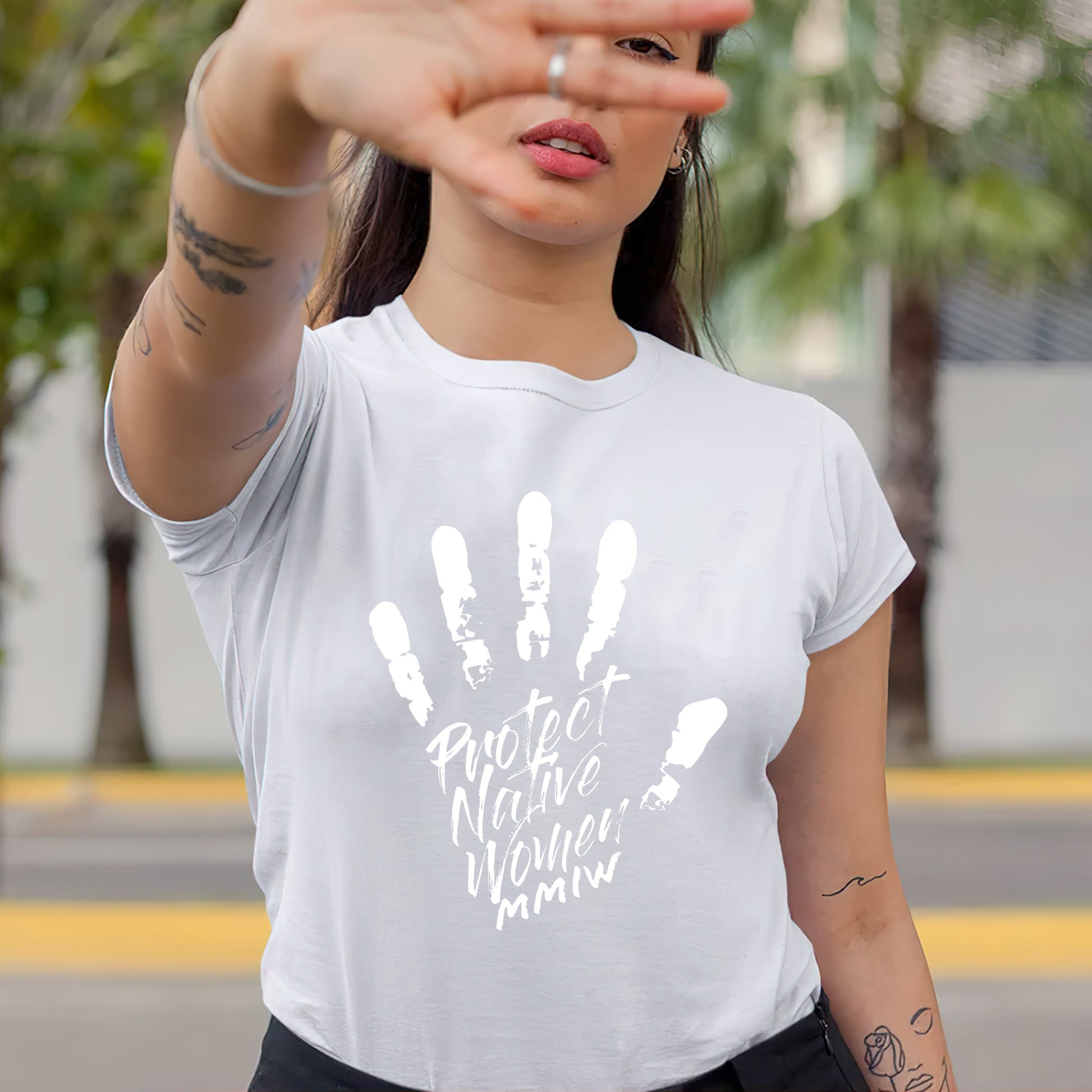 a woman wearing a t - shirt that says protect nature now