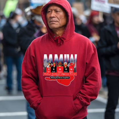 a man in a red hoodie stands in front of a crowd