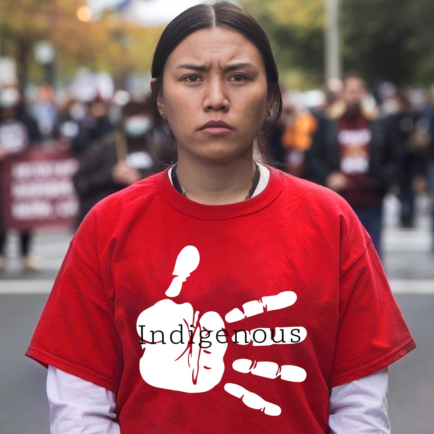 a woman wearing a red shirt with a hand painted on it