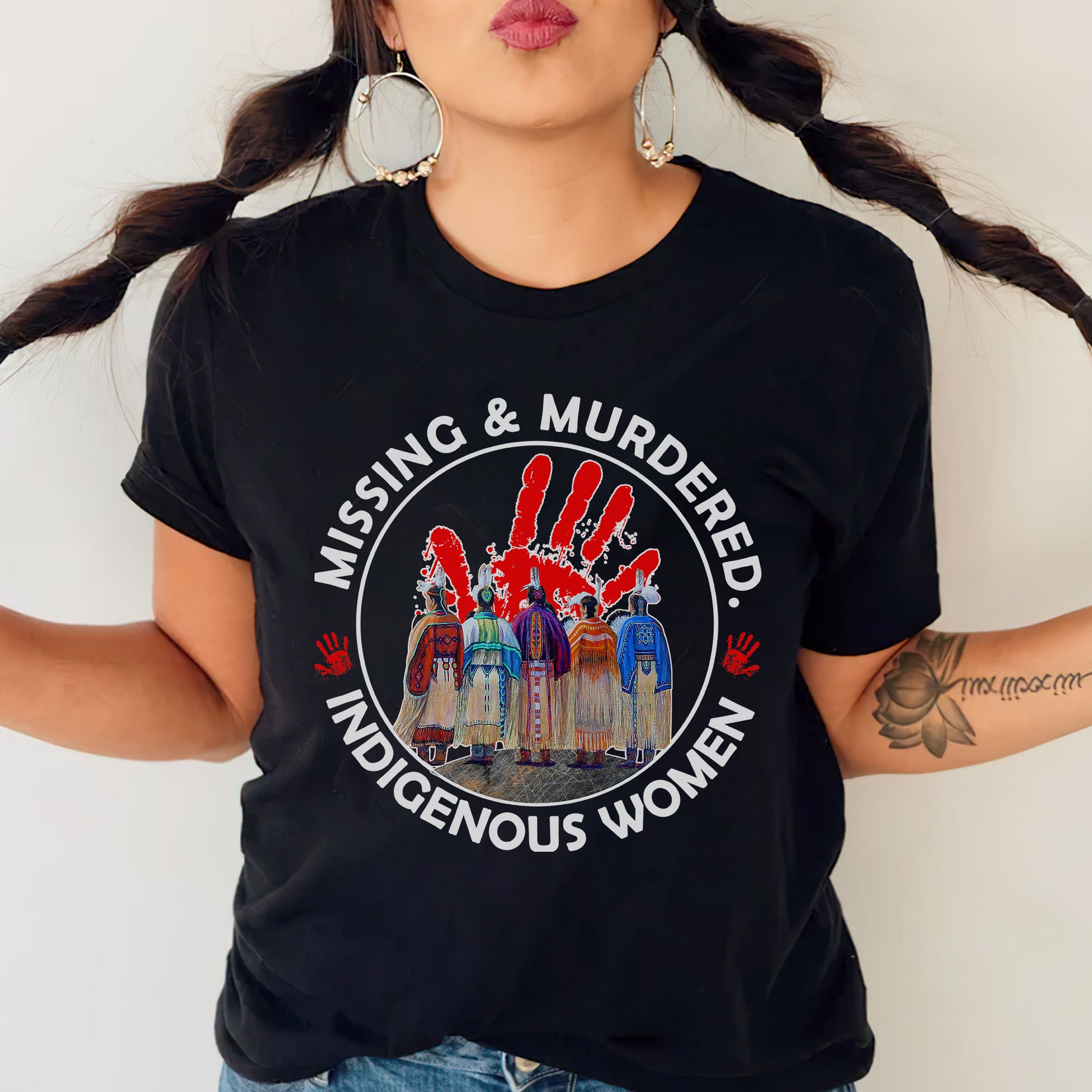 a woman wearing a black t - shirt with the words missing and murdered indigenous women