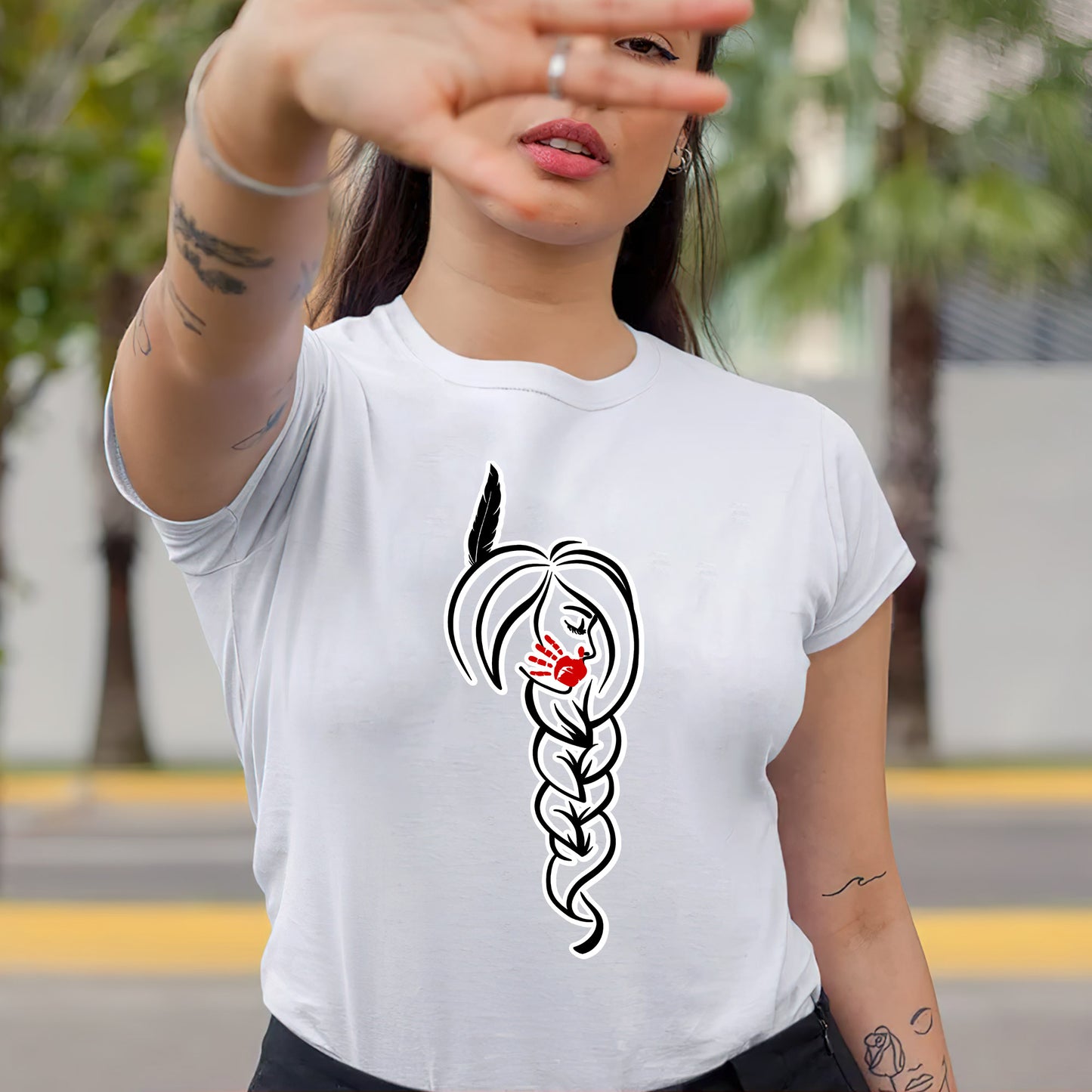 a woman wearing a t - shirt with a drawing of a snake on it