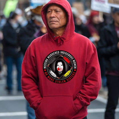 a man in a red hoodie stands in the middle of a crowded street