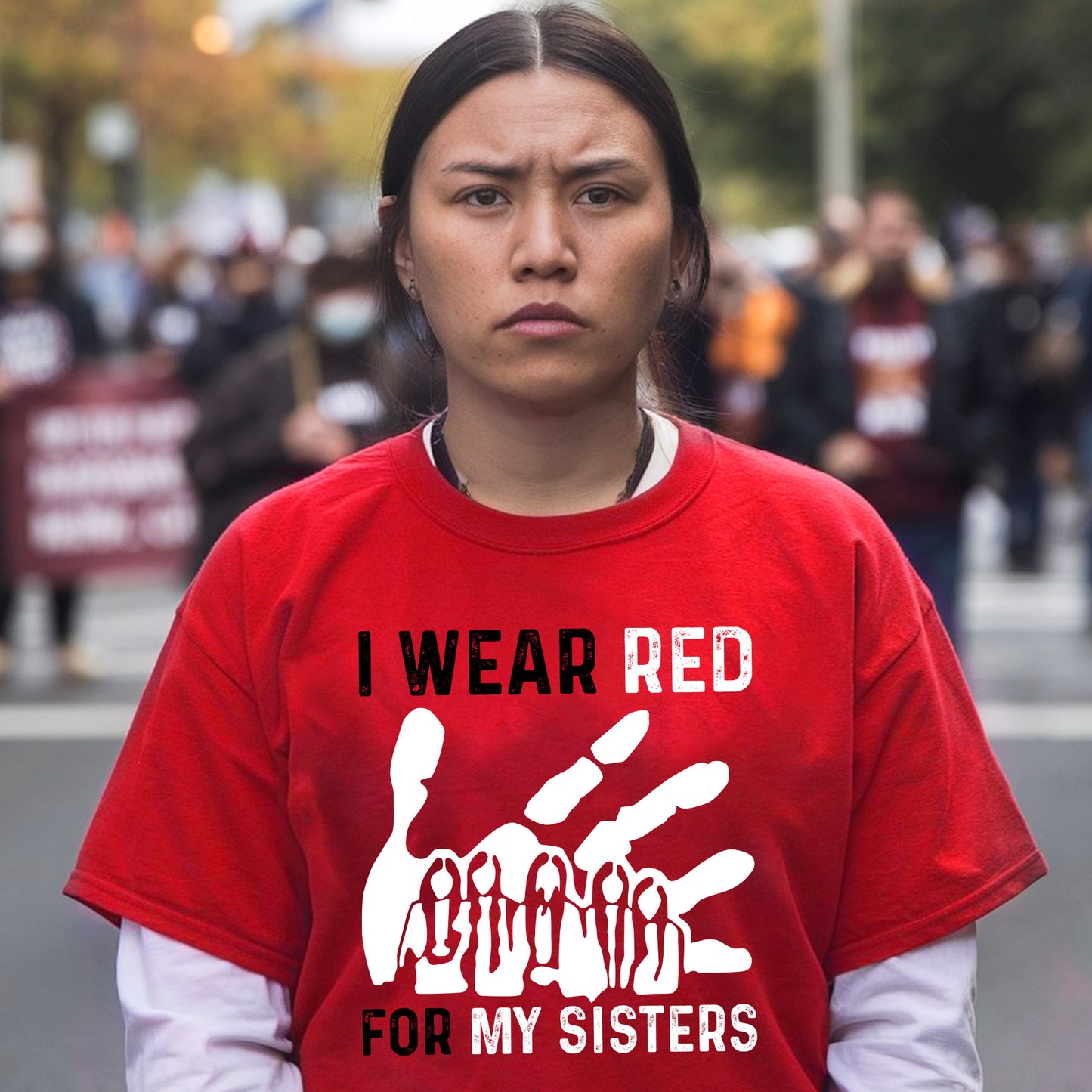 a woman in a red shirt is standing on the street