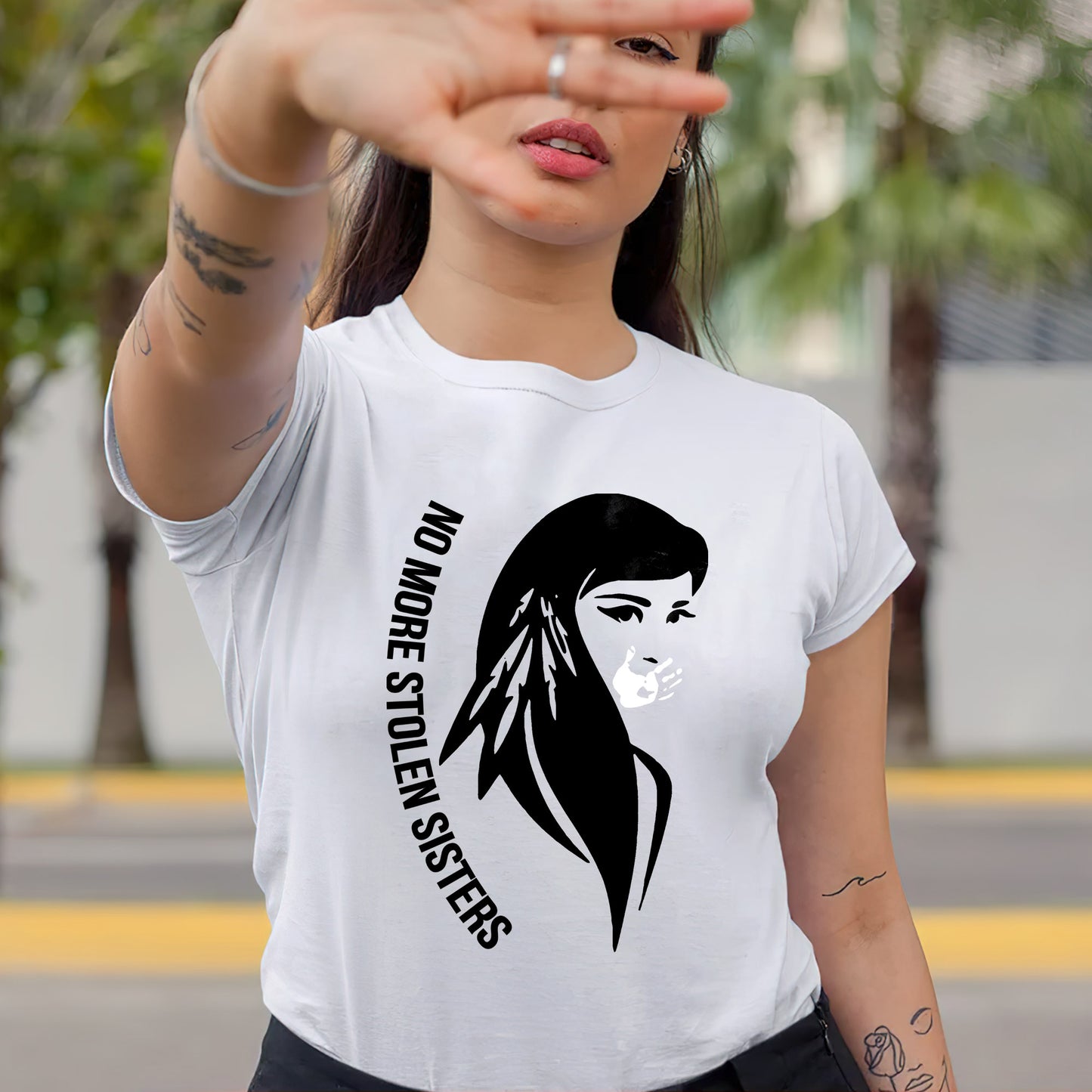 a woman wearing a white t - shirt with a black design on it