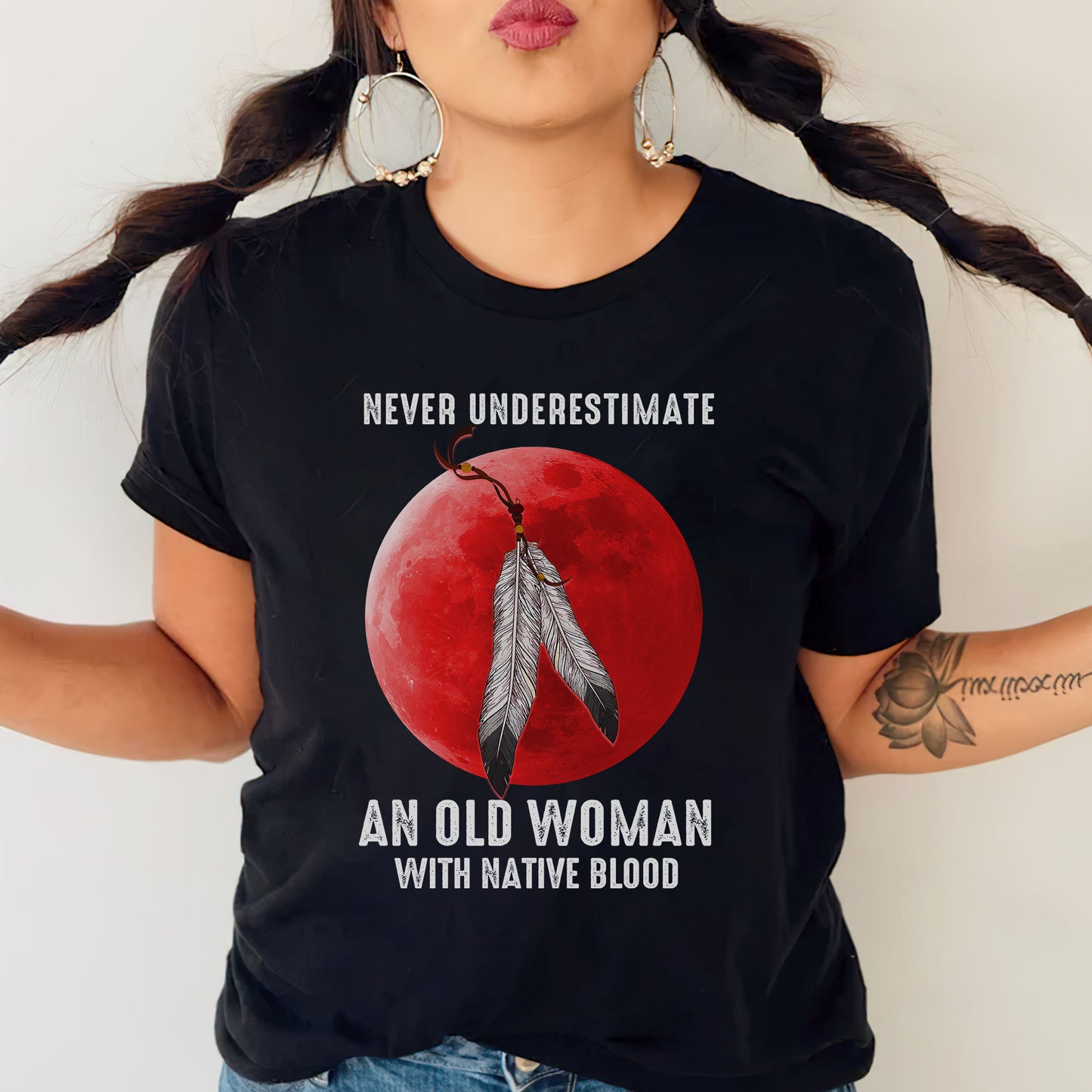 a woman wearing a t - shirt with a feather on it