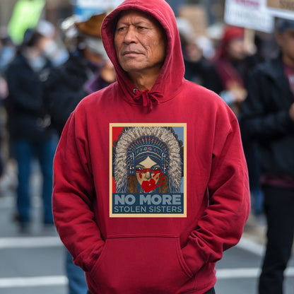 a man in a red hoodie stands in the middle of a crowded street