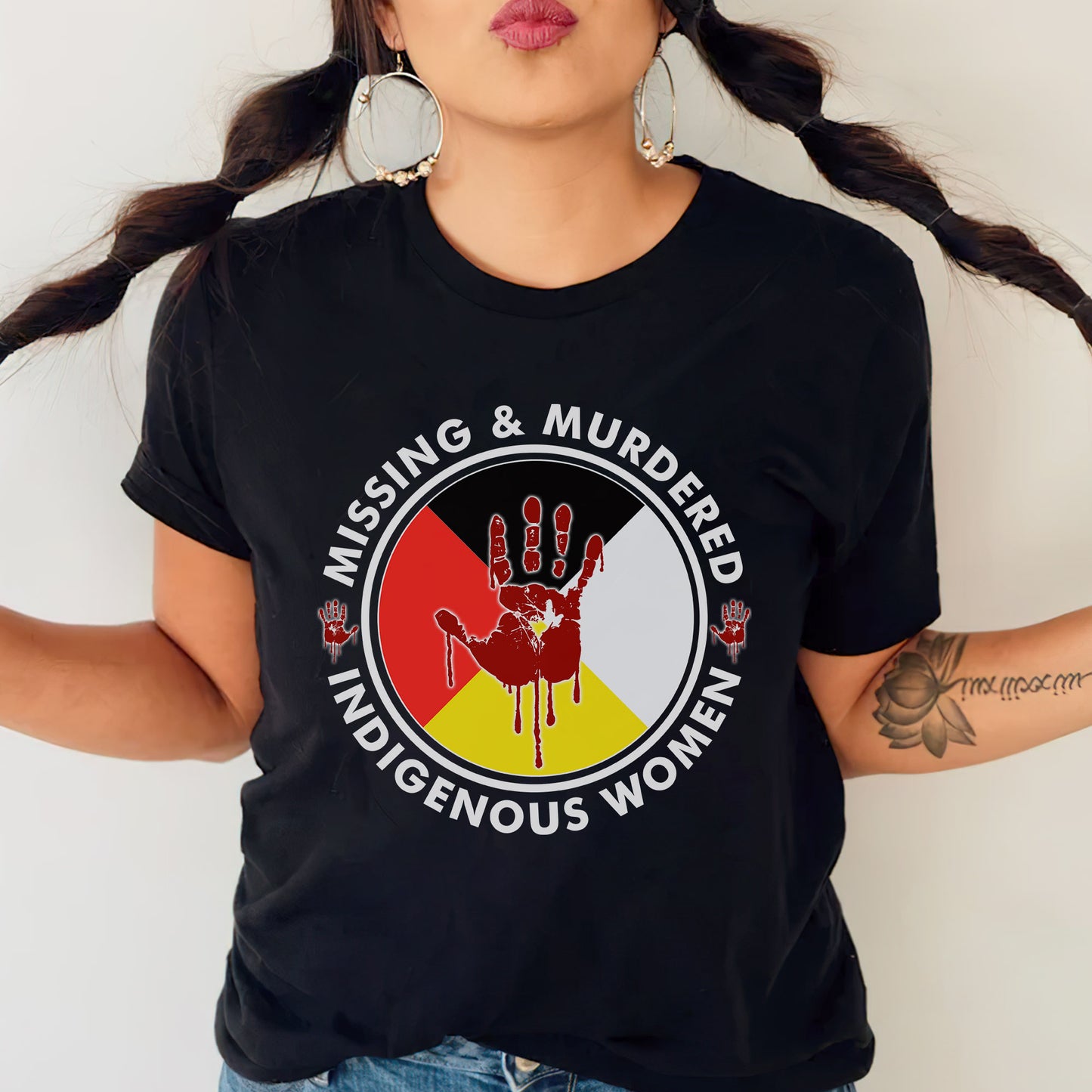 a woman wearing a black t - shirt with a red hand painted on it